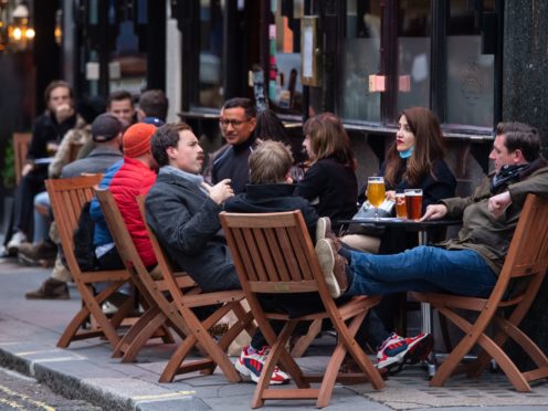 Customers outside a pub in Soho (Dominic Lipinski/PA)