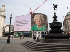 A quote from the Queen’s televised coronavirus address, seen on a screen in London’s Piccadilly Circus (Dominic Lipinski/PA)