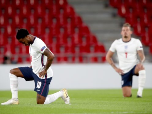 England’s Raheem Sterling (left) and Kalvin Phillips taking a knee (Nick Potts/PA)