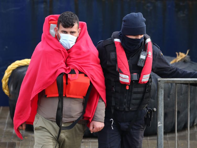 A group of people thought to be migrants are brought in to Dover, Kent. (Gareth Fuller/PA)