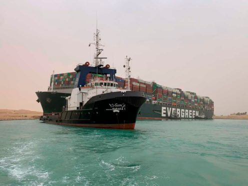 Suez Canal Authority boats come to the assistance of the Ever Given on Wednesday (Suez Canal Authority/AP)