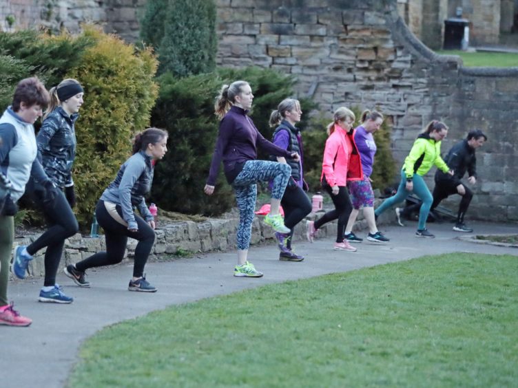 People taking part in a boot camp exercise class in Springhead Park, Rothwell, Leeds (Danny Lawson/PA)