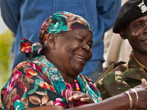 Sarah Obama, step-grandmother of then US President Barack Obama, shakes the hand of a well-wisher (Ben Curtis/AP)