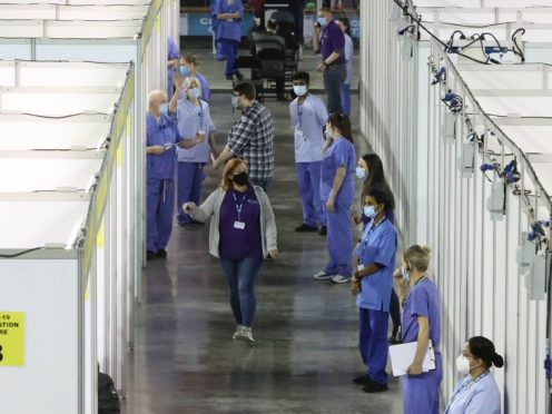 People attending the newly opened Covid-19 vaccination centre in the SSE Arena, Belfast (Liam McBurney/PA)