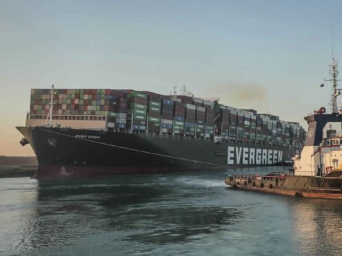 The Ever Given, a Panama-flagged cargo ship is pulled by one of the Suez Canal tugboats, in the Suez Canal, Egypt (Suez Canal Authority/PA)