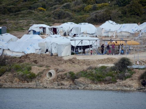 Migrants gather outside their tents at Karatepe refugee camp, on the eastern Aegean island of Lesbos, Greece (Panagiotis Balaskas/AP)