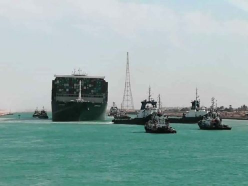 The Ever Given is accompanied by tugboats as it moves in the Suez Canal (Suez Canal Authority/AP)
