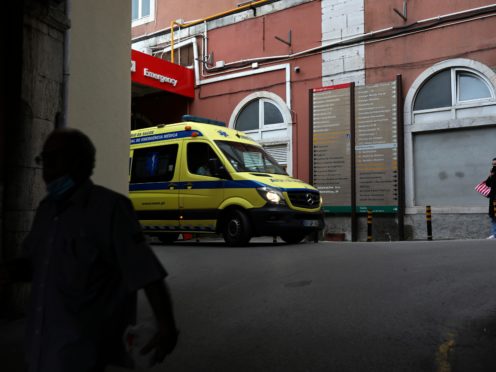 An ambulance leaves the emergency entrance of the Sao Jose Hospital in Lisbon, Monday, March 29, 2021. An Italian fugitive, convicted in his homeland of ordering the revenge killing of a mobster’s wife, was arrested in Portugal on Monday in a clinic where he was reportedly being treated for COVID-19. (AP Photo/Pedro Rocha)
