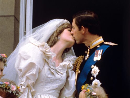 Diana and Charles kiss on the Palace balcony on their wedding day (PA)