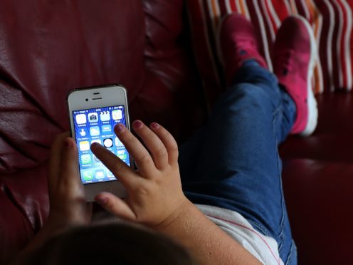 While parents are worried about children’s online spending, only 18% have spoken to them about it in the last six months, according to a survey (Peter Byrne/PA)