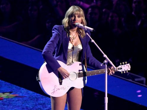 Taylor Swift’s re-recording of her album Fearless has topped the UK album chart (PA)