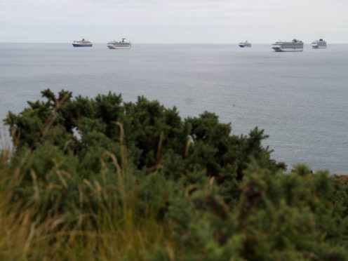 Cruise ships off Portland, Dorset amid a coronavirus-inspired slump in demand (Andrew Matthews/PA)