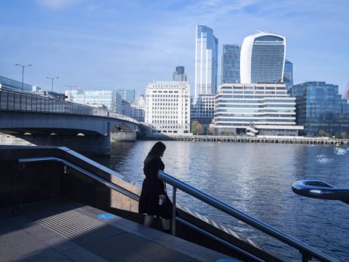 A woman walks down steps across from the City of London (Victoria Jones/PA)