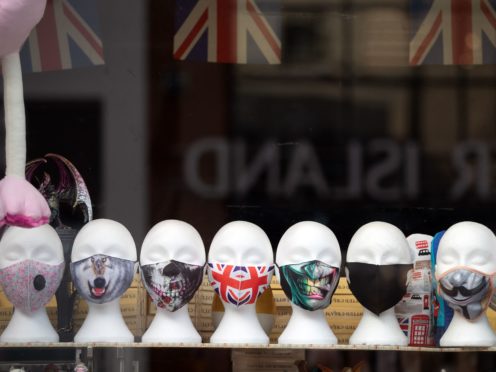 Face masks on display in a shop window (Andrew Matthews/PA)
