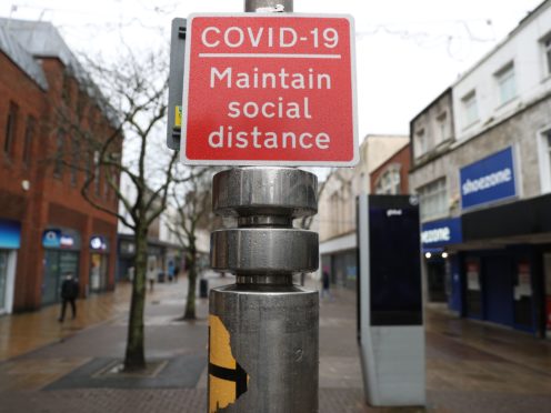 A Covid-19 social distancing sign (Andrew Matthews/PA)