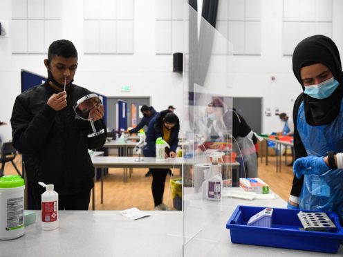 A student takes a lateral flow Covid-19 test at Hounslow Kingsley Academy in west London in March 2021 (Kirsty O’Connor/PA)