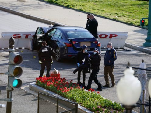 Authorities investigate the scene after a man rammed a car into two officers at the barricade on Capitol Hill in Washington (Alex Brandon/AP)