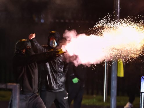 Youths fire fireworks at the PSNI on the Springfield road, during further unrest in Belfast (Liam McBurney/PA)