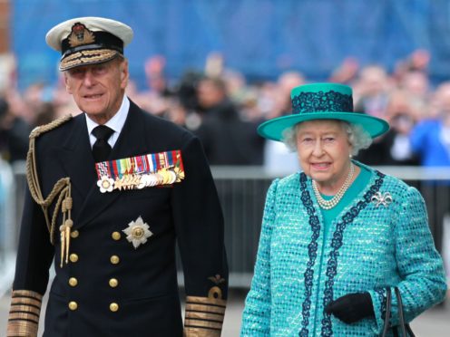 The Queen and the Duke of Edinburgh at the formal naming ceremony for HMS Queen Elizabeth in Rosyth Dockyard (PA)