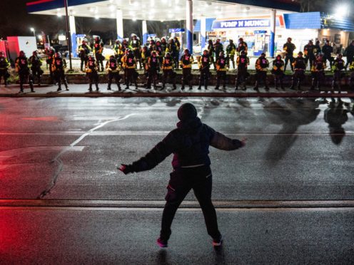 A demonstrator heckles authorities during a protest against the police shooting of Daunte Wright (John Minchillo/AP)