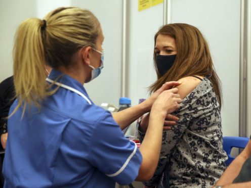 Caroline Nicolls receive an injection of the Moderna Covid-19 vaccine administered by nurse Amy Nash, at the Madejski Stadium in Reading, Berkshire (PA)