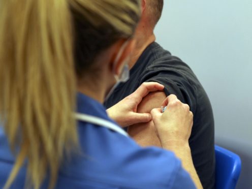 Mark Nicolls receives an injection of the Moderna Covid-19 vaccine (Steve Parsons/PA)