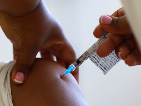 A health care worker receives a vaccine at a hospital in Khayelitsha, Cape Town, South Africa (Nardus Engelbrecht/AP)