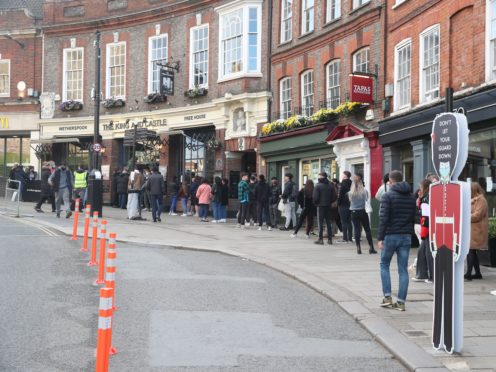 People queue outside the Wetherspoon’s King and Castle pub in Windsor, following the further easing of lockdown restrictions in England (Steve Parsons/PA)
