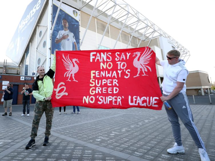 Fans protest outside the Leeds stadium against Liverpool’s decision to join a proposed new European Super League ahead of the clubs’ Premier League fixture (Zac Goodwin/PA)