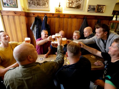 Customers cheer with beer at a pub in Prague, Czech Republic (Petr David Josek/AP)