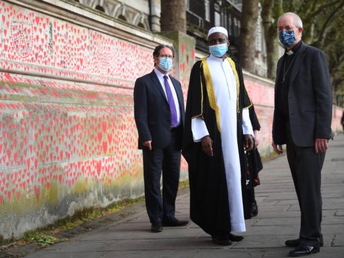 (l to r) Rabbi Daniel Epstein, Imam Kazeem Fatai and The Archbishop of Canterbury Justin Welby visit the wall (Victoria Jones/PA)
