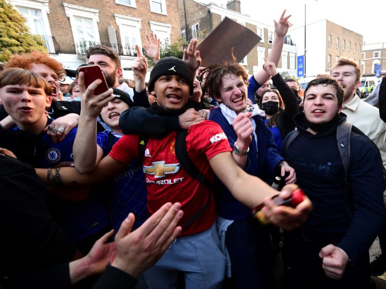 Fans react outside Stamford Bridge after the potential news that Chelsea are preparing to withdraw from the new European Super League (Ian West/PA)