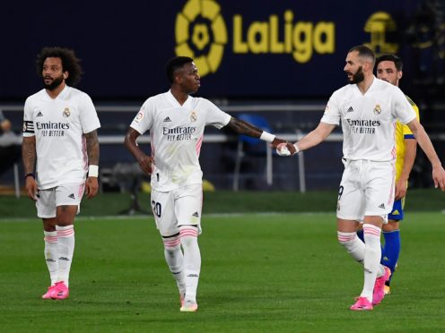 Real Madrid’s Karim Benzema, right, celebrates after scoring against Cadiz (Jose Breton/AP)