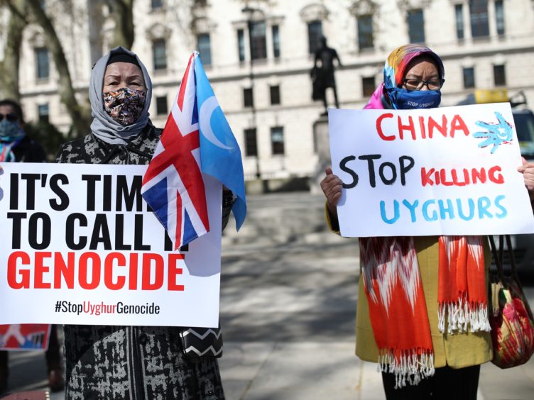 Uyghurs during a demonstration in Parliament Square (Yui Mok/PA)