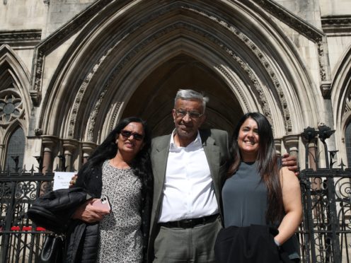 Former post office worker Vijay Parekh from Willesden, with his wife Gita (left) and daughter Bhavisha (Yui Mok/PA)