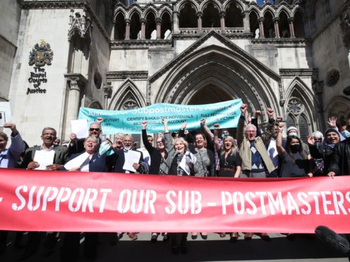 Former post office workers celebrating outside the Royal Courts of Justice (Yui Mok/PA)
