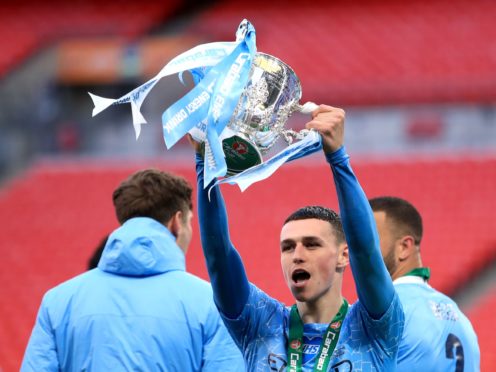 Manchester City’s Phil Foden celebrates with the trophy after collecting a fourth Carabao Cup winners’ medal (Adam Davy/PA)
