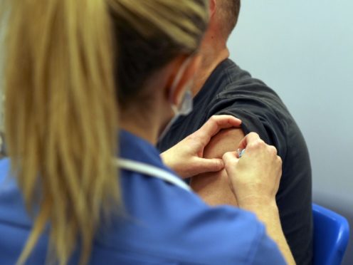 A patient receives an injection (Steve Parsons/PA)