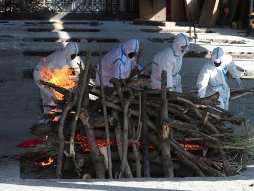 Family members of a Covid-19 victim perform the last rites at a crematorium in Jammu on Monday as the pandemic continued to worsen in India (Channi Anand/AP)