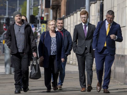 Joe McCann’s widow Anne (centre) and family, with their solicitor, Niall Murphy (right), arriving at Laganside Court in Belfast (Liam McBurney/PA)
