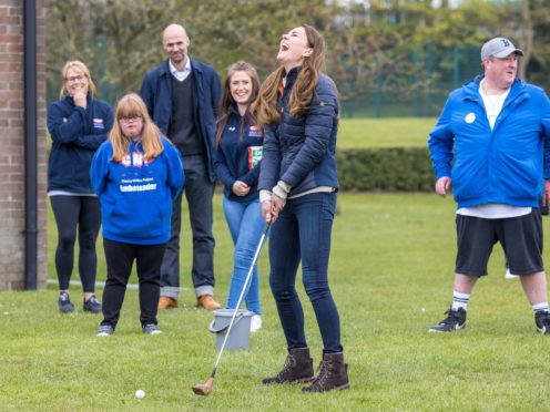 The Duchess of Cambridge laughs as she plays golf during a visit to the Cheesy Waffles Project in Durham (Andy Commins/PA)