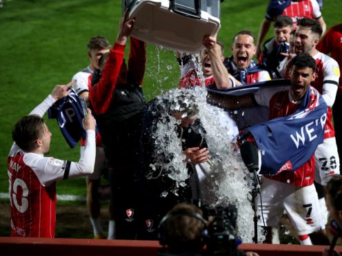Cheltenham players pour ice over manager Michael Duff (David Davies/PA)