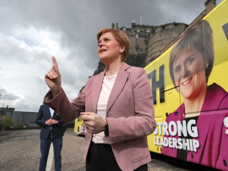 Scottish First Minister and leader of the SNP Nicola Sturgeon speaks in front of Edinburgh Castle (Russell Cheyne/PA)