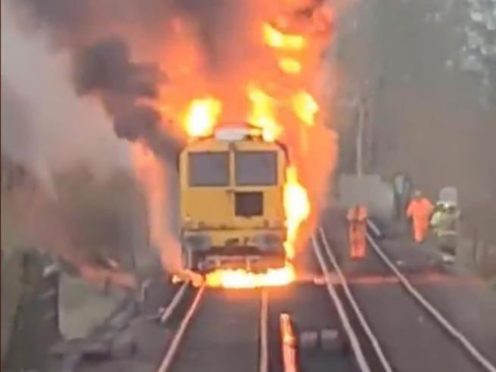 Firefighters battled in ‘difficult conditions’ to put out a blazing engineering train which caused a railway line to be closed (Network Rail/PA)