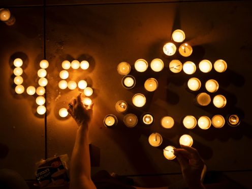 People light candles in memory of the 45 ultra-Orthodox Jews killed in a stampede at a religious festival (AP Photo/Oded Balilty)