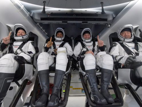 Nasa astronauts Shannon Walker, Victor Glover and Mike Hopkins, and Japan Aerospace Exploration Agency astronaut Soichi Noguchi (Nasa via AP)