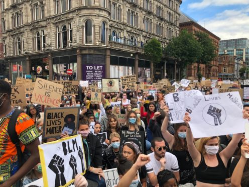 People participate in a Black Lives Matter protest rally march through Donegall Square in Belfast (David Young/PA)
