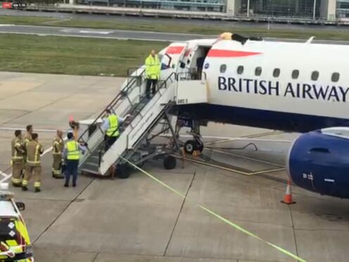 Paralympian James Brown lying top of a British Airways plane at City Airport, London (Extinction Rebellion/PA)