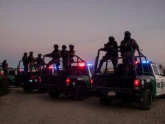 Mexican police stand guard near the Rio Grande river in Ciudad Acuna, Mexico, at dawn (AP Photo/Felix Marquez)