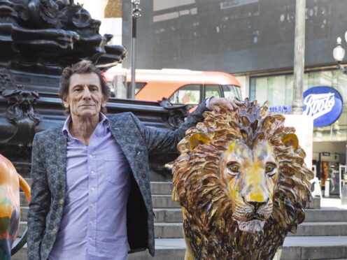 Rolling Stones guitarist Ronnie Wood with the lion he designed (Joshua Bratt/PA)